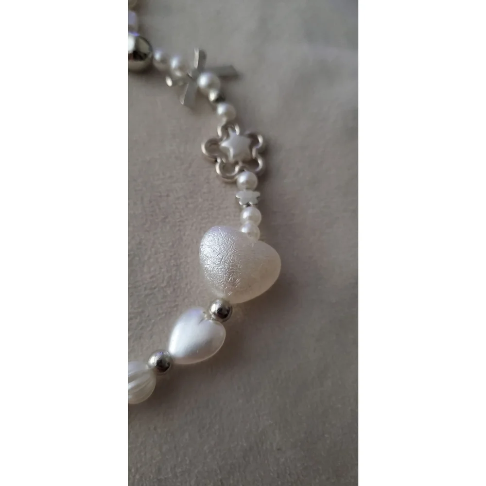 Phone chain with a variety of white & silver-tone beads, including faux pearls
